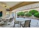 Covered patio featuring desert landscaping, multiple seating areas, and a ceiling fan at 2801 Byron Dr, Las Vegas, NV 89134