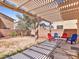 Inviting backyard patio under a pergola, perfect for outdoor gatherings and relaxation at 3040 Balcones Fault Ave, North Las Vegas, NV 89081
