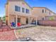 Spacious backyard with a covered patio, colorful furniture, string lights, and space to design your ideal outdoor area at 3040 Balcones Fault Ave, North Las Vegas, NV 89081