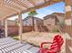 Backyard patio with pergola cover, brick privacy fence, and a palm tree at 3040 Balcones Fault Ave, North Las Vegas, NV 89081