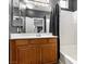 Bathroom vanity featuring a wood cabinet and white countertop next to a shower at 3040 Balcones Fault Ave, North Las Vegas, NV 89081