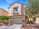 Two-story home featuring a two-car garage, desert landscaping, and a neutral color stucco exterior at 3040 Balcones Fault Ave, North Las Vegas, NV 89081