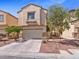 Two-story home featuring a two-car garage, desert landscaping, and a neutral color stucco exterior at 3040 Balcones Fault Ave, North Las Vegas, NV 89081