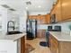 Kitchen featuring oak cabinets, stainless steel appliances, granite countertops, and tile flooring at 3040 Balcones Fault Ave, North Las Vegas, NV 89081