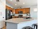 Kitchen featuring oak cabinets, stainless steel appliances, granite countertops, and tile flooring at 3040 Balcones Fault Ave, North Las Vegas, NV 89081