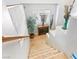 View of the staircase with carpeted steps, a wooden handrail and white banisters, and a decorative table at the landing at 3040 Balcones Fault Ave, North Las Vegas, NV 89081