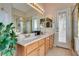 Bathroom vanity with double sinks, large mirror, shower, and outdoor access at 3088 Paseo Mountain Ave, Henderson, NV 89052