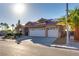 Charming single-story home with a tile roof, three-car garage, solar panels, and well-manicured landscaping at 3088 Paseo Mountain Ave, Henderson, NV 89052
