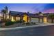 Charming single-story home at twilight with a tile roof, three-car garage, solar panels, and drought-resistant landscaping at 3088 Paseo Mountain Ave, Henderson, NV 89052