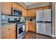 A well-equipped kitchen with stainless steel appliances, granite countertops, and custom wood cabinets at 3088 Paseo Mountain Ave, Henderson, NV 89052