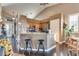 A modern kitchen features a granite breakfast bar, stainless steel appliances, and hardwood floors at 3088 Paseo Mountain Ave, Henderson, NV 89052