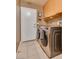 Functional laundry room features modern washer and dryer and cabinet storage at 3088 Paseo Mountain Ave, Henderson, NV 89052
