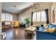 Bright living room with hardwood floors, high ceilings, large windows, stylish furniture, and modern decor at 3088 Paseo Mountain Ave, Henderson, NV 89052