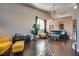 Spacious living room with hardwood floors, a cozy seating area, a modern chandelier, and contemporary decorations at 3088 Paseo Mountain Ave, Henderson, NV 89052
