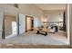 Spacious bedroom features large mirror, a comfortable bed with couch, and walk-in closet doors at 3088 Paseo Mountain Ave, Henderson, NV 89052