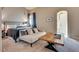 Spacious bedroom features comfortable bed with couch and view of the primary bathroom at 3088 Paseo Mountain Ave, Henderson, NV 89052