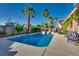 Captivating pool area featuring a clear blue swimming pool, mature palm trees, and an inviting patio with seating at 3088 Paseo Mountain Ave, Henderson, NV 89052