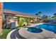 Inviting pool area with an attached spa, manicured landscaping, mature trees, and an outdoor lounge space at 3088 Paseo Mountain Ave, Henderson, NV 89052