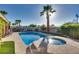 Refreshing pool and spa combo surrounded by lush landscaping, mature palm trees, and a serene patio area at 3088 Paseo Mountain Ave, Henderson, NV 89052