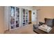 Cozy study features bright window, desk, bookcases, and comfortable arm chair with foot stool at 3088 Paseo Mountain Ave, Henderson, NV 89052