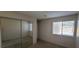 Bedroom view showcases mirrored closet doors and window with privacy blinds at 3151 Soaring Gulls Dr # 1074, Las Vegas, NV 89128