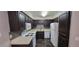 Kitchen featuring sleek, dark cabinetry, light countertops, and white appliances at 3151 Soaring Gulls Dr # 1074, Las Vegas, NV 89128