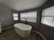 Bathroom featuring a modern soaking tub by a large bright window at 3340 Shallow Pond Dr, Las Vegas, NV 89117