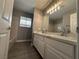 Modern bathroom featuring double sinks, a large mirror, and contemporary lighting fixtures at 3340 Shallow Pond Dr, Las Vegas, NV 89117