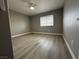 Bedroom features wood look flooring, a ceiling fan, and a window at 3340 Shallow Pond Dr, Las Vegas, NV 89117