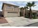 Two-story stucco home with a two-car garage, balcony, and desert landscaping at 3340 Shallow Pond Dr, Las Vegas, NV 89117