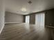 Spacious living room featuring modern flooring and natural light from sliding glass doors at 3340 Shallow Pond Dr, Las Vegas, NV 89117