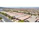 Long angle aerial shot of suburban homes in a vibrant community with desert landscaping and paved streets at 379 Mano Destra Ln, Henderson, NV 89011