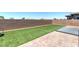 Large backyard with artificial turf and secure wall fencing, great for pets and outdoor activities at 379 Mano Destra Ln, Henderson, NV 89011