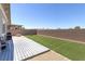 Inviting backyard with artificial turf, a patio, and secure brick wall fencing, offering low maintenance at 379 Mano Destra Ln, Henderson, NV 89011