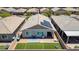 Aerial of a backyard with artificial grass, a paver patio, and solar panels installed on the roof at 379 Mano Destra Ln, Henderson, NV 89011