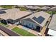 An aerial view of a modern backyard design, featuring artificial grass, pavers, and solar panels at 379 Mano Destra Ln, Henderson, NV 89011