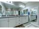 Large bathroom vanity with dual sinks, large mirror, and modern fixtures at 379 Mano Destra Ln, Henderson, NV 89011