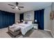 Cozy bedroom with soft carpet, ceiling fan, and decorative blue curtains and throw pillows at 379 Mano Destra Ln, Henderson, NV 89011