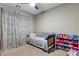 Bedroom with a trundle bed, toy organizer, and patterned curtains at 379 Mano Destra Ln, Henderson, NV 89011