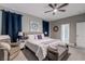Spacious bedroom featuring a ceiling fan, neutral colors, and comfortable seating area at 379 Mano Destra Ln, Henderson, NV 89011