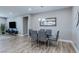 Bright dining room with modern chandelier, table with seating for six, and wood-look floors at 379 Mano Destra Ln, Henderson, NV 89011