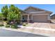 Beautiful single-story home with desert landscaping, brick accents, and a two-car garage at 379 Mano Destra Ln, Henderson, NV 89011
