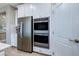 Bright kitchen featuring stainless steel appliances, double oven and white shaker style cabinets at 379 Mano Destra Ln, Henderson, NV 89011