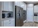 Bright kitchen featuring white cabinets, stainless steel appliances, and subway tile backsplash at 379 Mano Destra Ln, Henderson, NV 89011