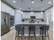 Bright kitchen boasts a large island, white cabinetry, stainless steel appliances, and pendant lighting at 379 Mano Destra Ln, Henderson, NV 89011