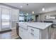 Bright kitchen featuring a large island with sink, stainless steel appliances, and access to living room at 379 Mano Destra Ln, Henderson, NV 89011