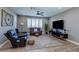 Comfortable living room with modern furniture, window shutters, and a ceiling fan at 379 Mano Destra Ln, Henderson, NV 89011
