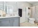 Bathroom with gray vanity, white walls, and full shower at 3966 Crystal Trip Ct, Las Vegas, NV 89129