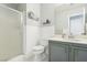 Clean bathroom with a glass-enclosed shower, white toilet, grey vanity, and modern fixtures at 3966 Crystal Trip Ct, Las Vegas, NV 89129