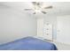 A bedroom featuring light gray walls, a modern ceiling fan, and minimalist furniture, creating a serene space at 3966 Crystal Trip Ct, Las Vegas, NV 89129